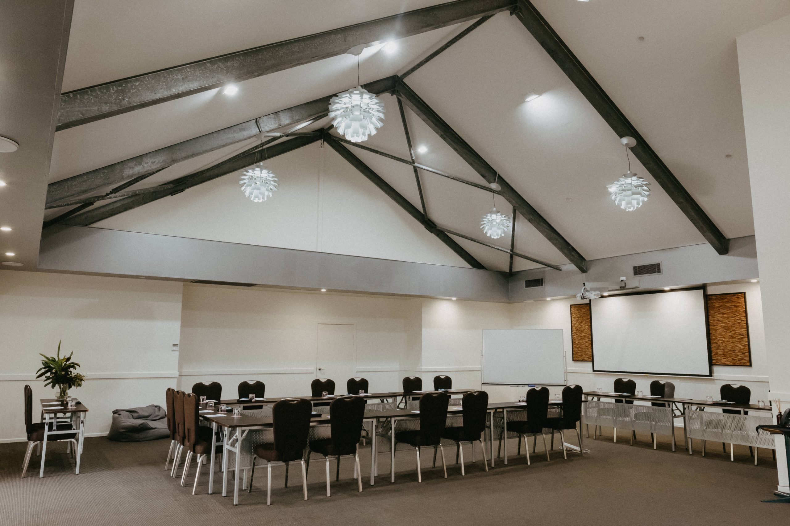 Banksia conference room at Mercure Clear Mountain with 4 metre industrial ceilings and natural light, set up in classroom style